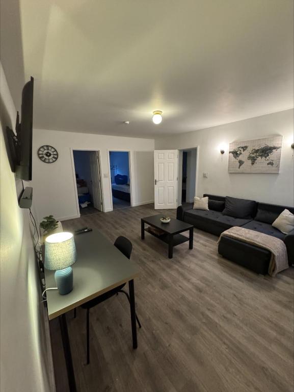 a living room with a couch and a table at Executive 4Bedroom Sleeps 9 City Centre Nearby in Parkside