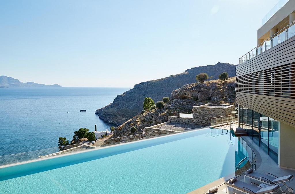 a swimming pool with a view of the ocean at Lindos Blu Luxury Hotel-Adults only in Líndos