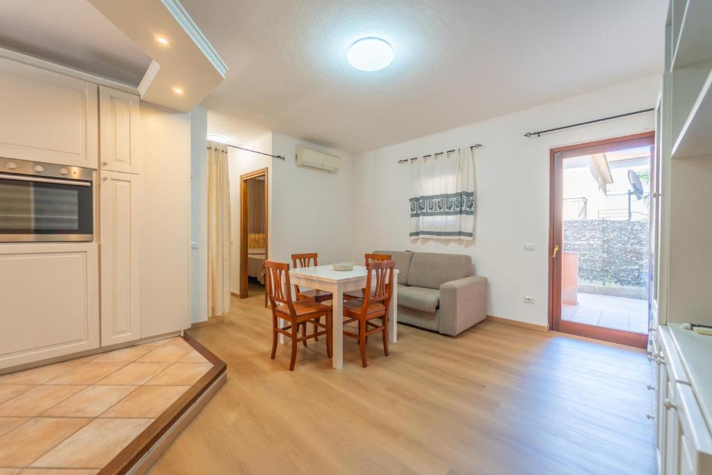 a kitchen and living room with a table and chairs at casa laura in Olbia