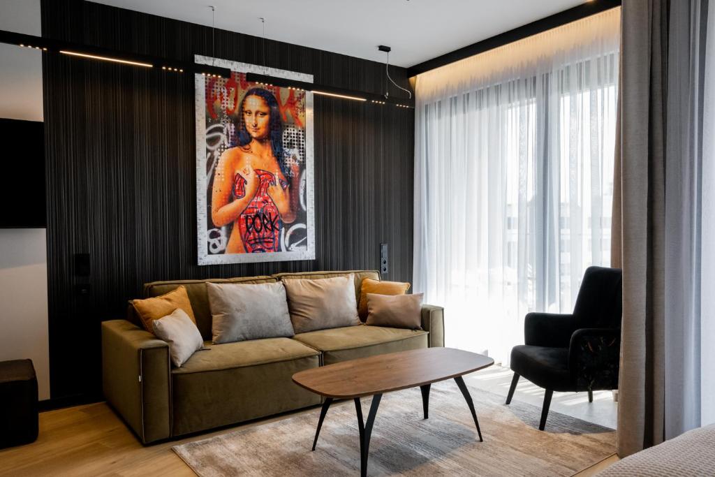 OlsztynにあるOmega Lake Premium Apartmentsのソファとテーブルのあるリビングルーム