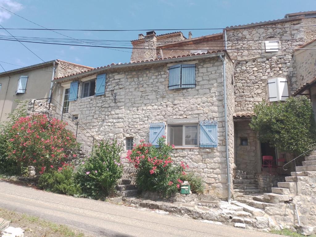 an old stone house on the side of a street at Maison ardéchoise atypique in Chomérac