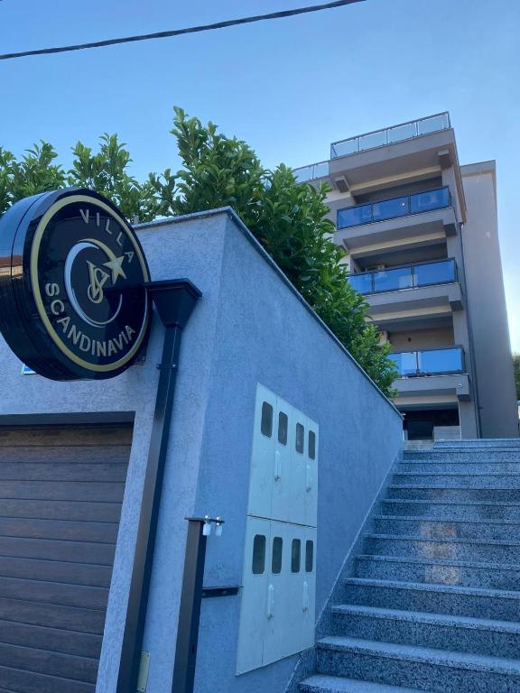 a clock on the side of a building with stairs at Villa Scandinavia in Mostar