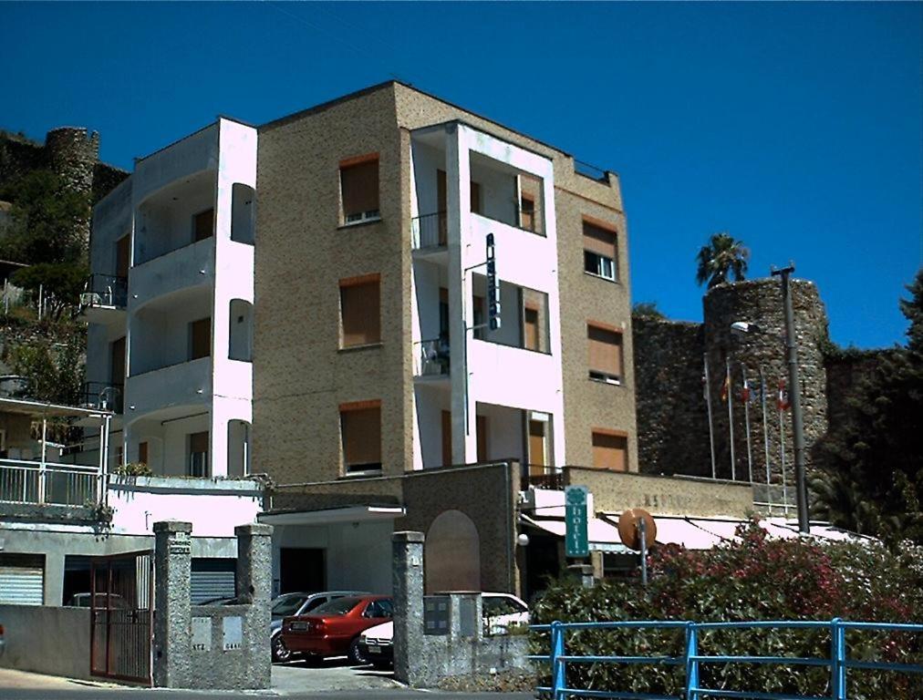 a building with a car parked in front of it at Hotel Gino in Noli