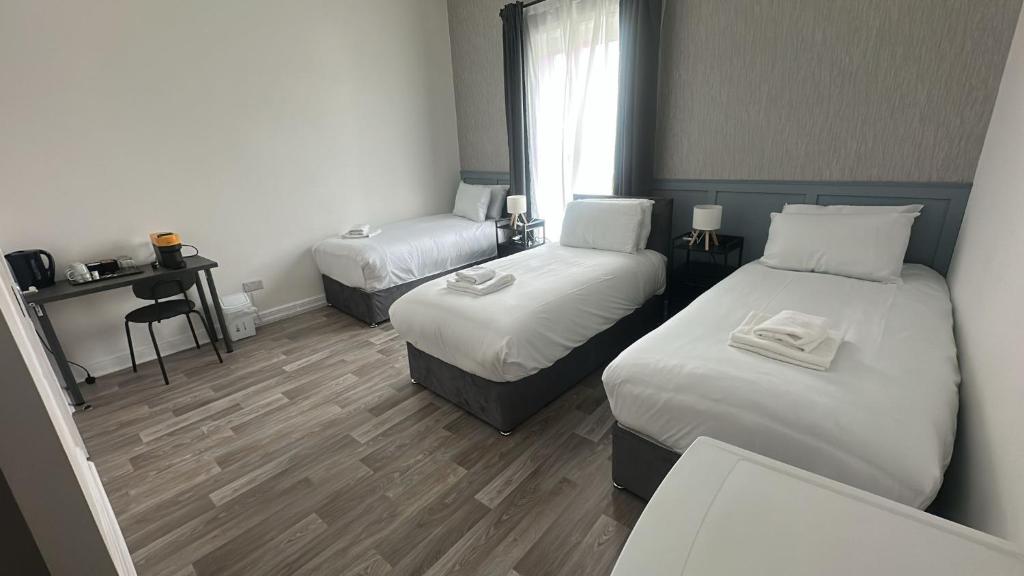 a hotel room with two beds and a window at Saint Annes Guest House - 22 Berkeley in Dublin
