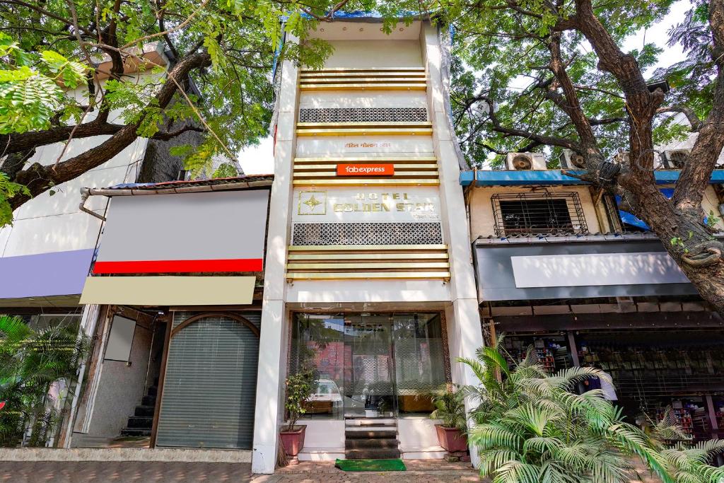 a tall building with a ladder in front of it at FabHotel Golden Star in Mumbai