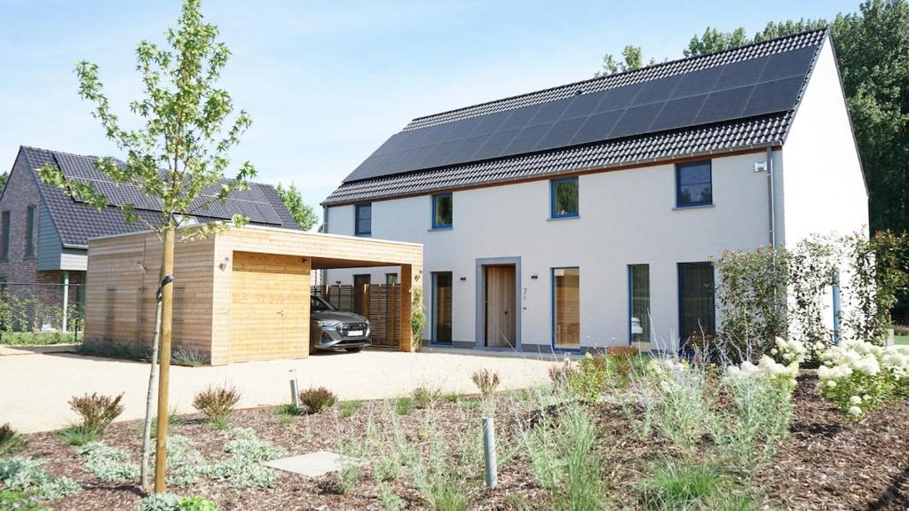 a house with solar panels on the roof at Villa Jeanne Dusschaut in Flobecq