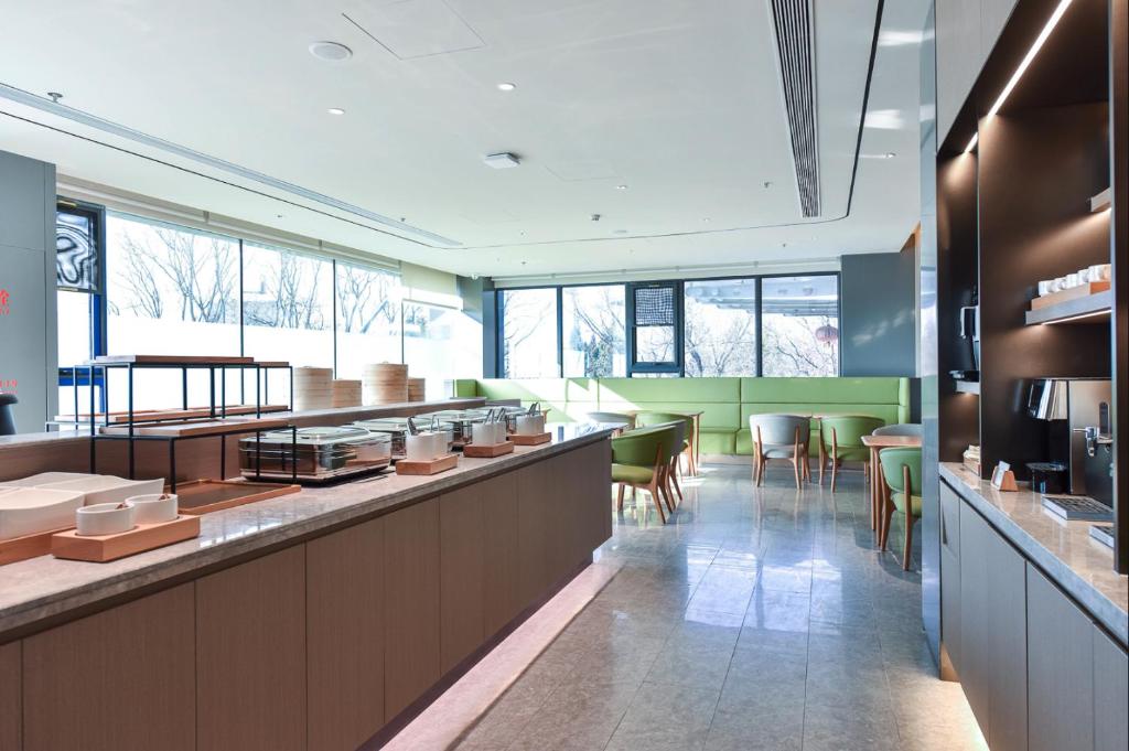 un ristorante con bar con sedie e tavoli di JI Hotel Beijing Shunyi Yanjing Bridge a Shunyi