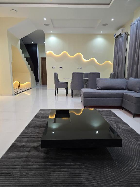 a living room with a couch and a table at 5 Bedroom semi detached Apartment by Ellestar Homes in Lekki