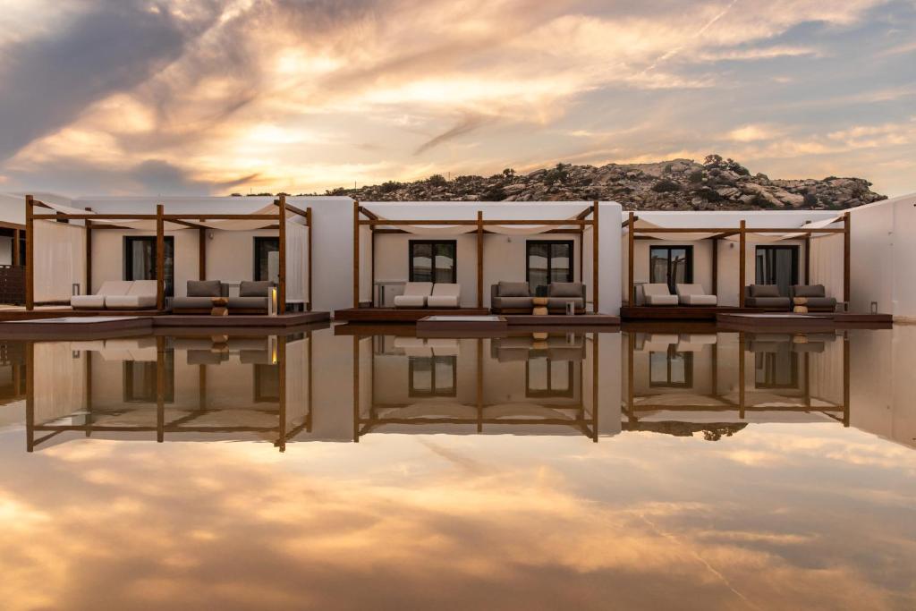 a house with its reflection in the water at Laguna Coast Resort, Small Luxury Hotels of the World in Stelida