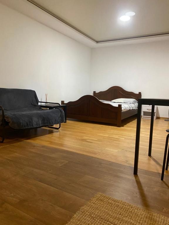 a room with two beds and a couch in it at Студія, апартаменти Cozy Classic in Myrhorod