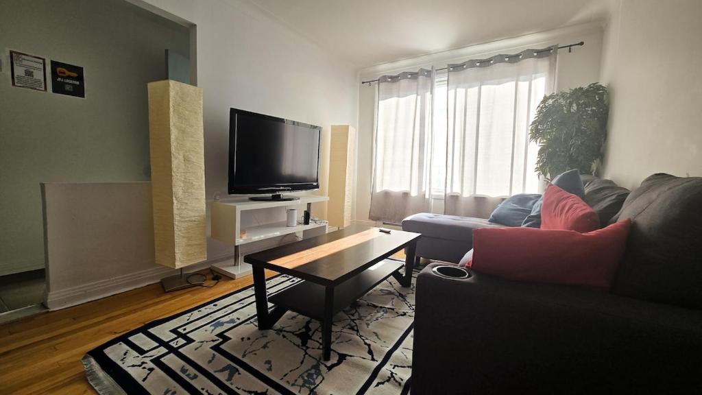 a living room with a couch and a tv at nice 3 bedrooms appartment for rent in Montréal
