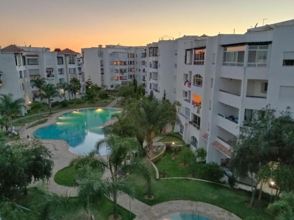 an aerial view of an apartment complex with a swimming pool at Apparemment asilah marina golf in Asilah