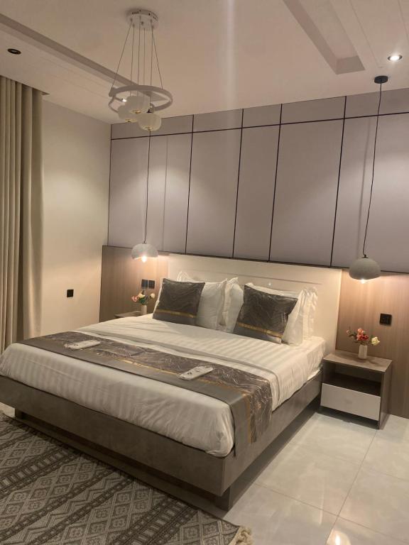 a bedroom with a large bed with a large headboard at mariella 1 in Jeddah