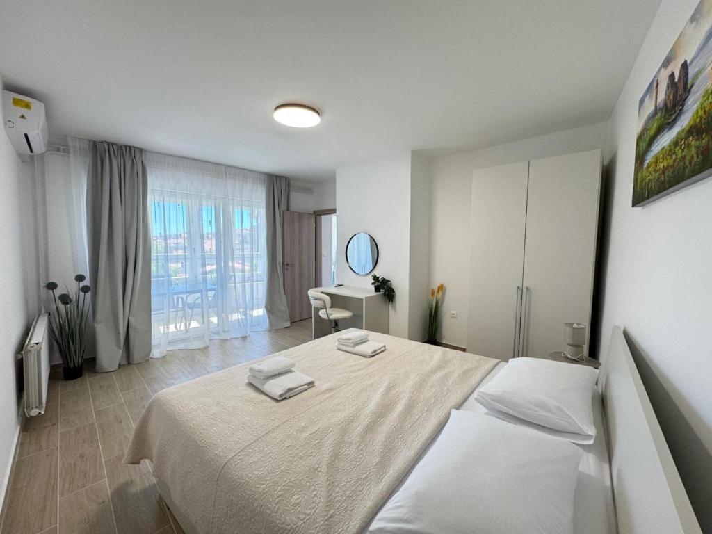 a bedroom with a bed with two towels on it at Flowers Apartments Pula, city center in Pula