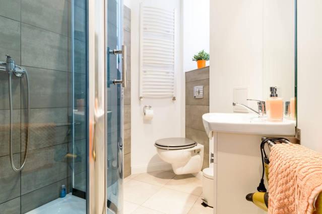 a bathroom with a shower and a toilet and a sink at Apartament Centrum in Poznań