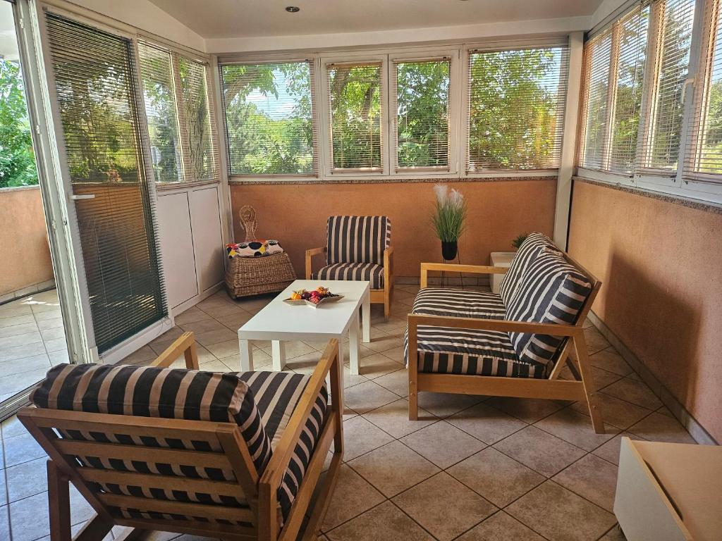 a screened in porch with two chairs and a table at Apartment 40 in Zagreb