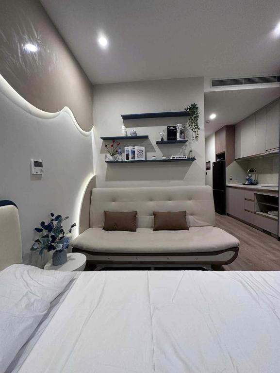 a living room with a bed and a kitchen at Hạ Long Homestay ICON40 in Ha Long