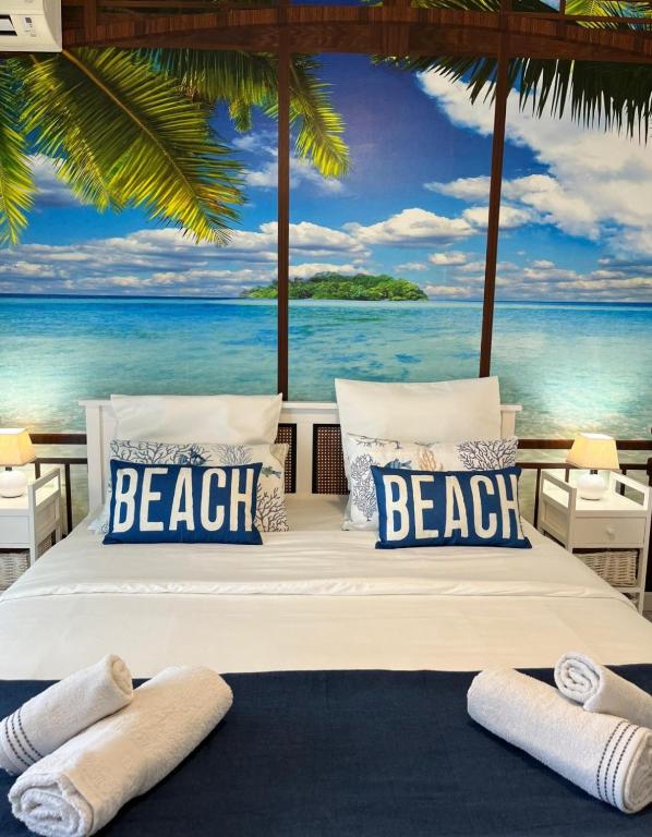 a beach bedroom with a view of the ocean at Ti Paradis 1 in Les Trois-Îlets