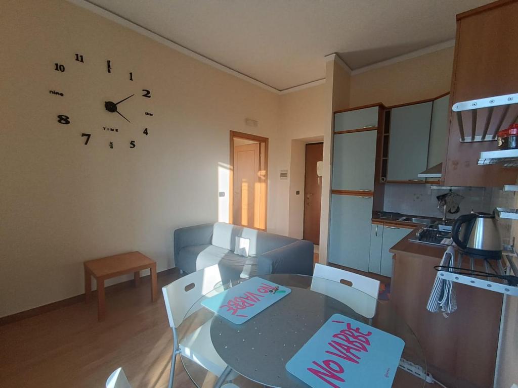a kitchen with a table and a clock on the wall at Maria Carolina Suite in Caserta