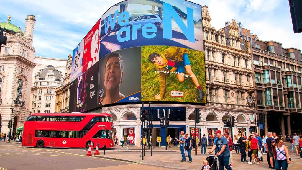 a red double decker bus on a busy city street at Posh Soho Studio Large Windows by Oxford St, Mayfair W1 in London