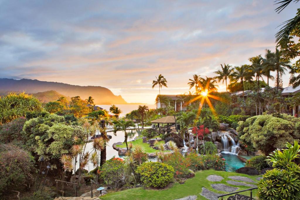 a view of a resort with a waterfall and a pool at Hanalei Bay Resort in Princeville