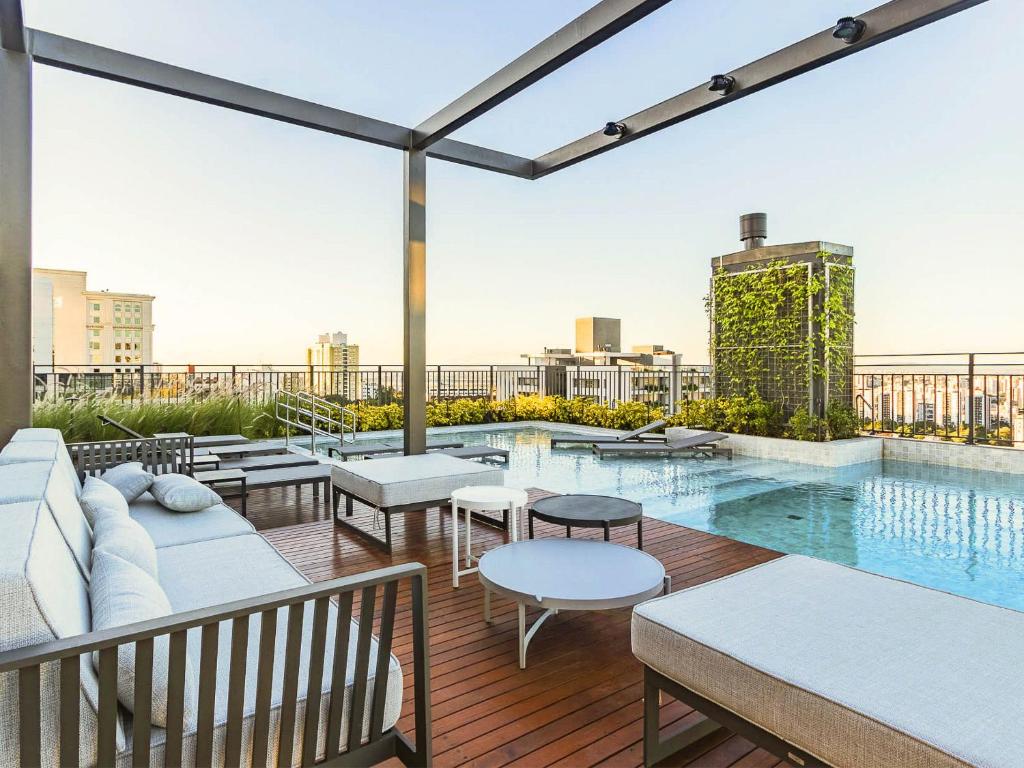 a rooftop patio with a pool on a building at GO Carlos Gomes by My Way in Porto Alegre