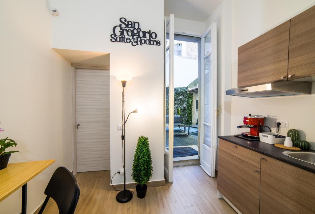 a kitchen with a sink and a counter top at San Gregorio Suite&Rooms in Naples