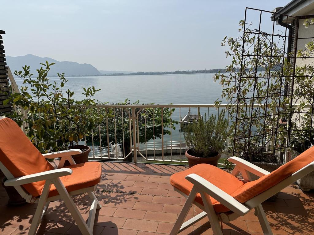 a patio with two chairs and a view of the water at La terrazza Iseana in Predore