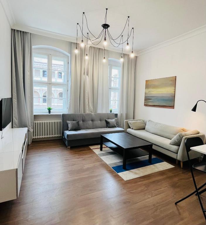 a living room with a couch and a table at Apartament VIS a VIS Koziołków in Poznań