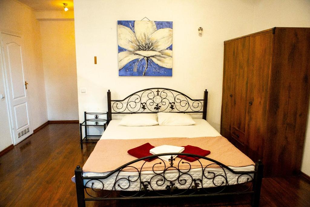 a bedroom with a bed and a painting on the wall at Doba In Ua Centre Apartments in Dnipro