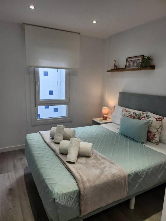 a bedroom with a large bed with pillows on it at Summer Malpica - calma junto al mar in Malpica