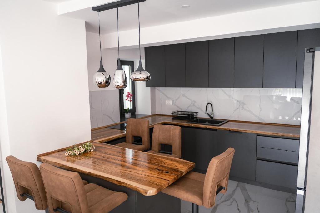 a kitchen with a wooden table and chairs at Galija in Tomislavgrad