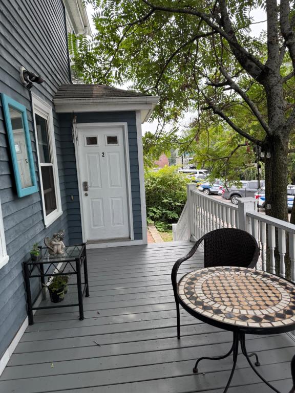 a cat sitting on a table on a porch at Beautiful 2-Bedroom, 2-Bath Townhouse in Boston