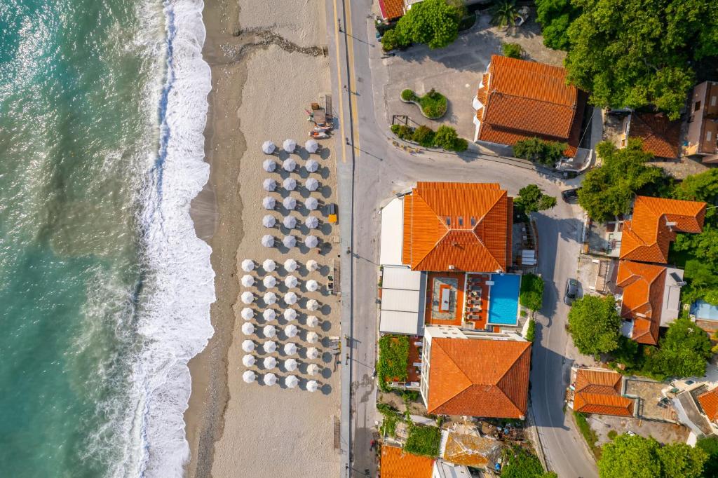 an overhead view of a beach with a group of buildings at Kelly Beach Hotel in Agios Ioannis Pelio