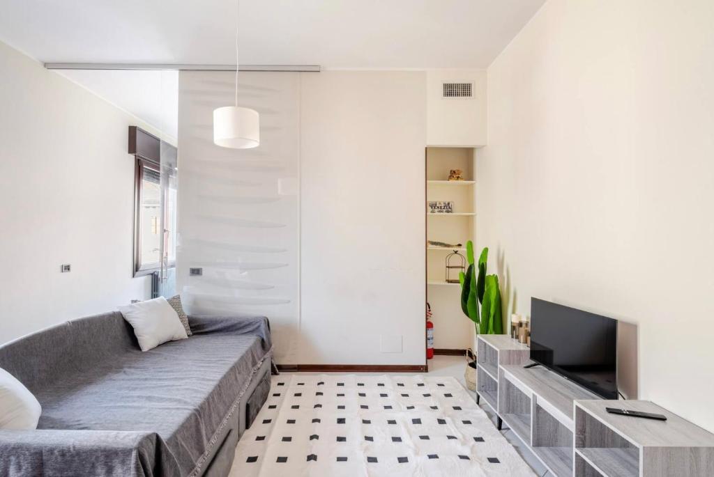 a living room with a couch and a tv at Venice Shore Apartment in Venice