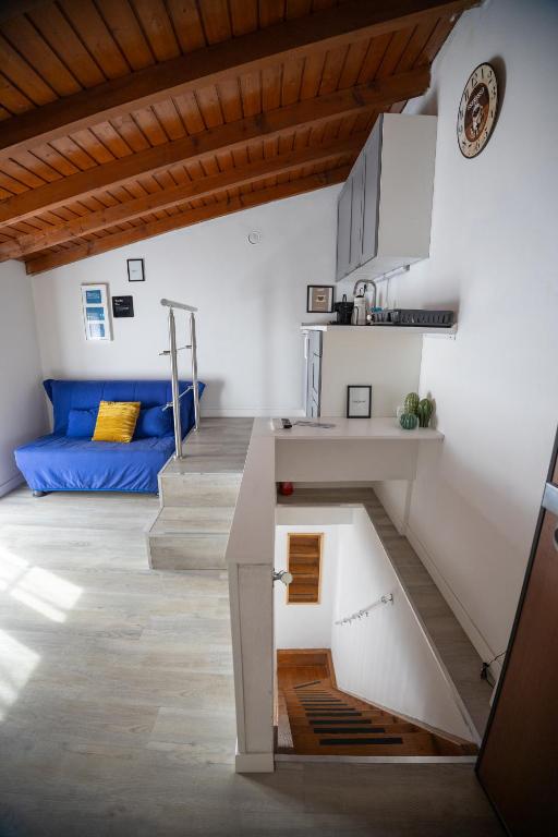 a staircase leading up to a living room with a couch at Duplex San Fedele in Como