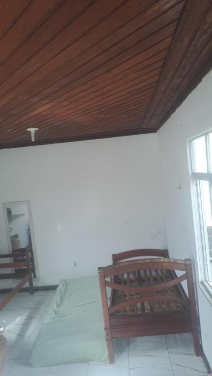 a bedroom with a bed and a wooden ceiling at casacop30belem in Belém