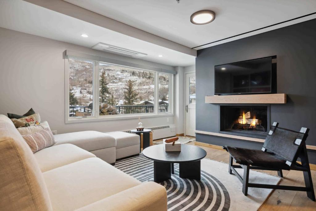 a living room with a couch and a fireplace at Lodge Tower 486 Two Bedroom Residence in Vail