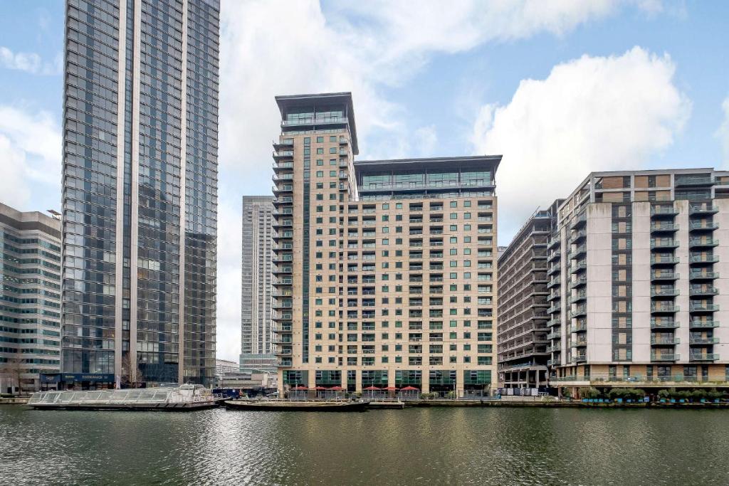 a group of tall buildings next to a body of water at Spare Room in All-Female 2-Bedroom Flat-Female Only! in London