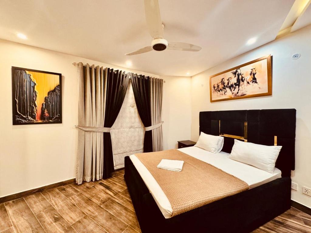 a bedroom with a bed and a window at 2 Bedroom Cozy Apartment by Lux Haven Stays in Lahore
