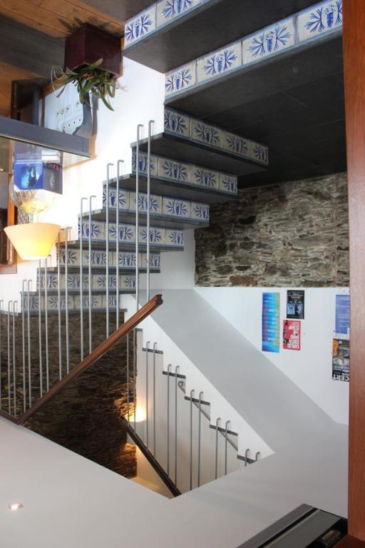 a staircase with blue and white signs on the wall at Hostal Cristina in Cadaqués