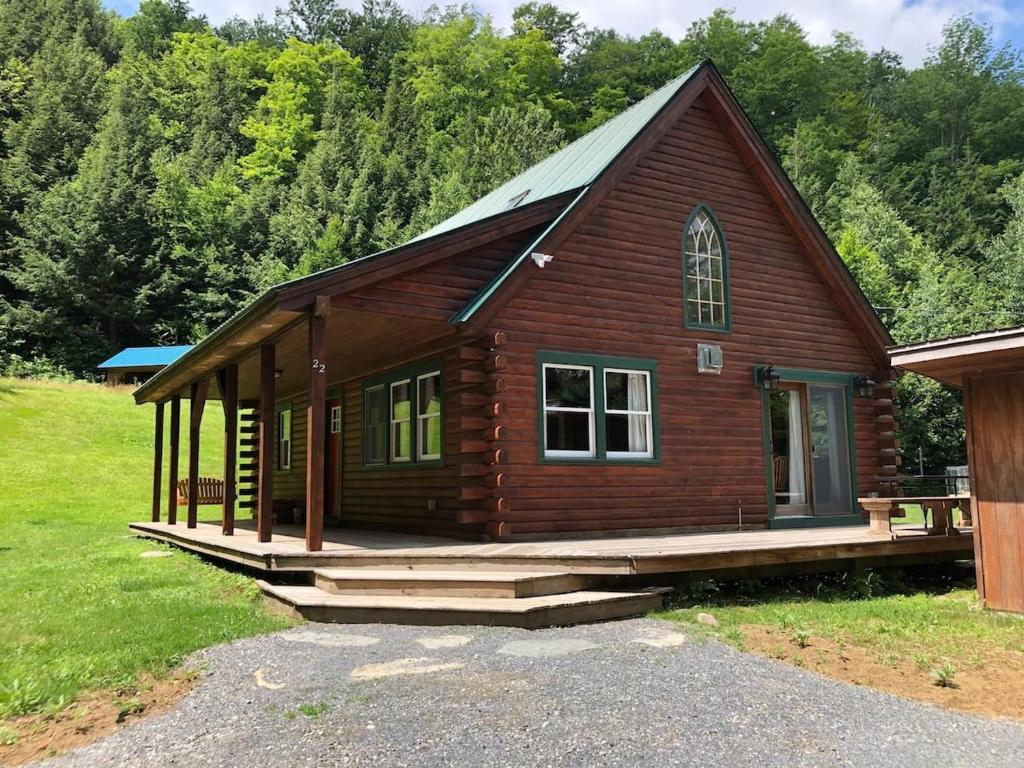 a small wooden cabin with a porch and a porch at Charming Vermont Log Cabin in Cambridge