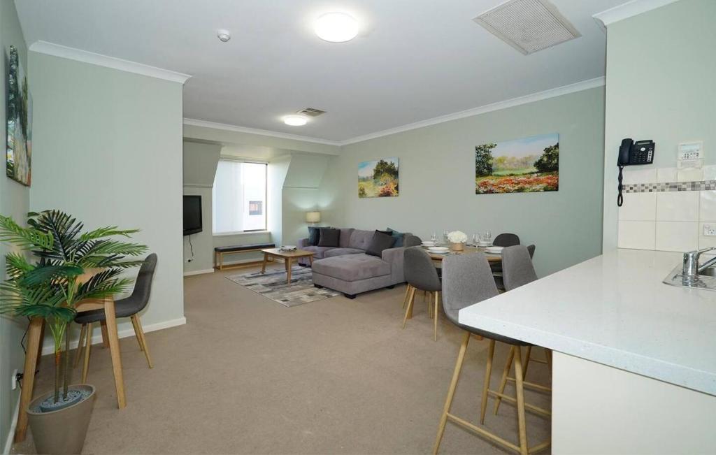 a living room with a couch and a table at 40 Modern & Chic Apt In East Perth in Perth