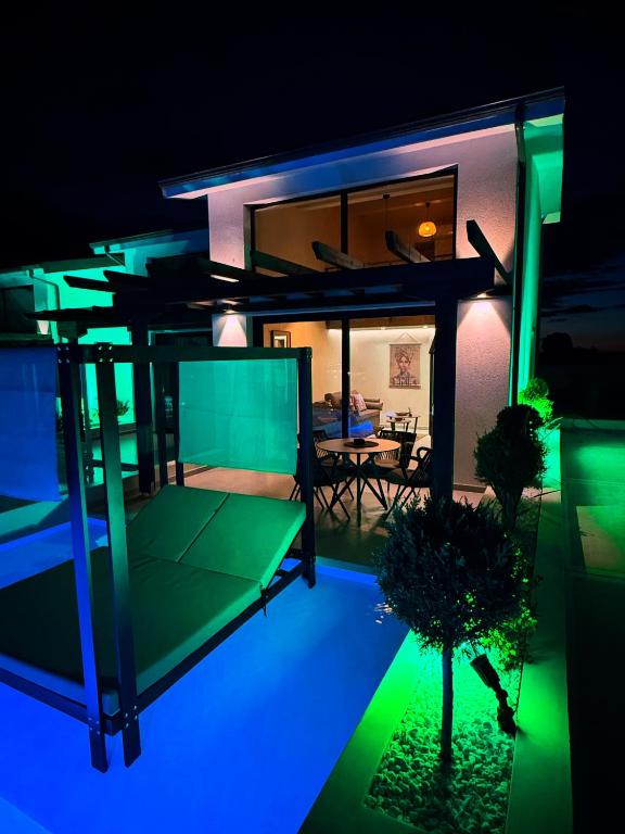 a view of a house at night with lights at STELIA Villa Halkidiki in Kallithea Halkidikis