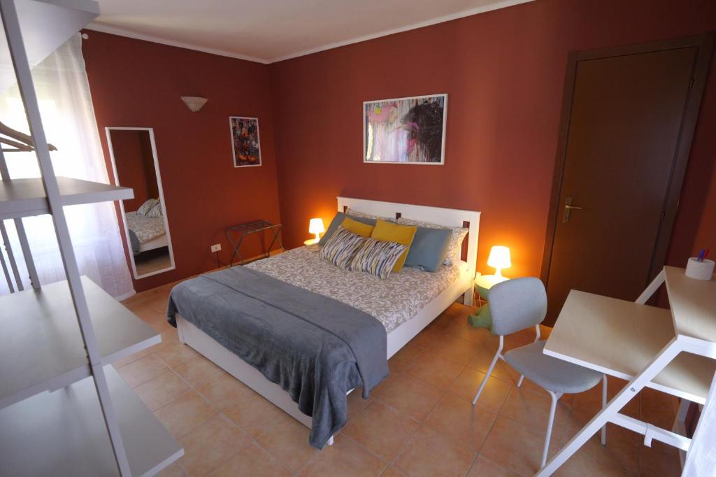 a bedroom with a bed and a table and chairs at Maison dans la rue in Gassino Torinese