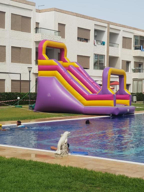 a water slide in a swimming pool with a water park at Puerto banus beach Apt Famillies and married couples in Mansouria