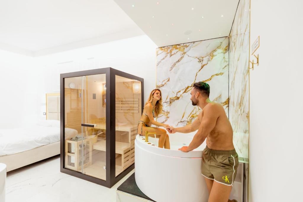 ナポリにあるDove Dormire a Napoli New Opening 2025の部屋の浴槽に立っている男性と女性