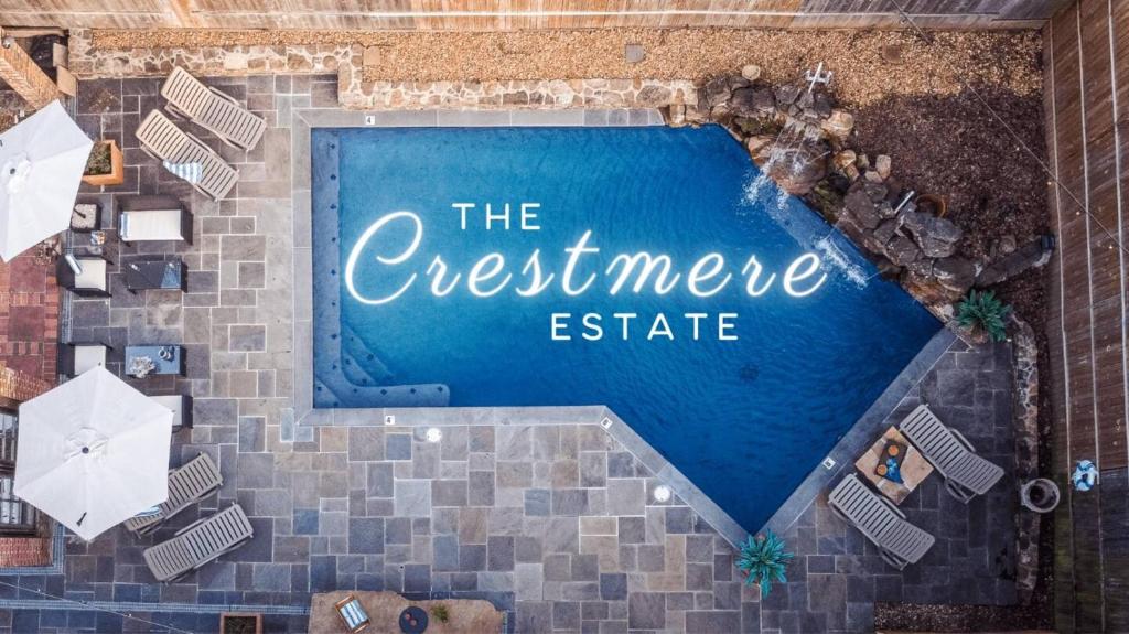 an overhead view of a swimming pool with the guest meete sign at Heated Poolhistoric Tudor Homecrestmere Estate in Memphis