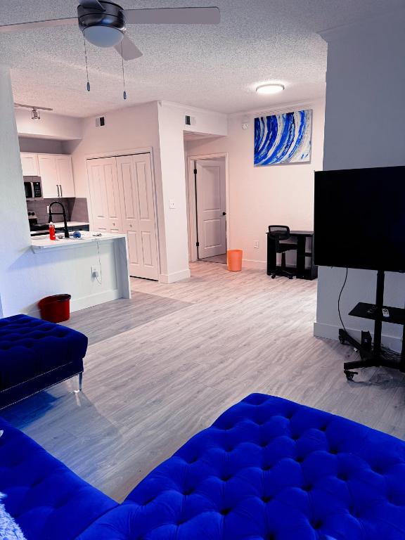 a living room with a blue couch and a kitchen at No Judgement Zone Relaxing Arlington Entertainment District in Arlington