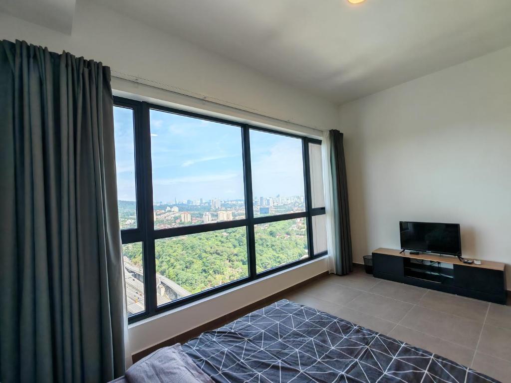 a bedroom with a large window with a view at Mossaz minimalist studio 3 in Petaling Jaya